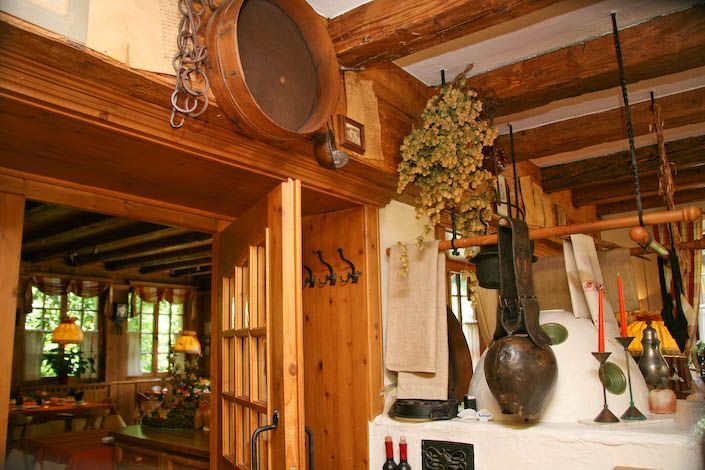 Zwei Flaschen Wein stehen auf einem Ofen in einem Holzraum