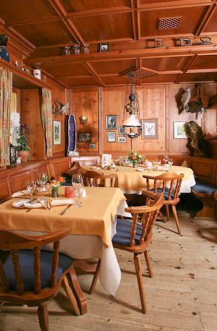 Ein Restaurant mit Tischen und Stühlen und einer Holzdecke