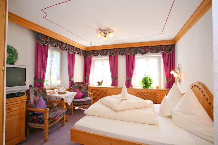 Ein Schlafzimmer mit großem Bett und Flachbildfernseher