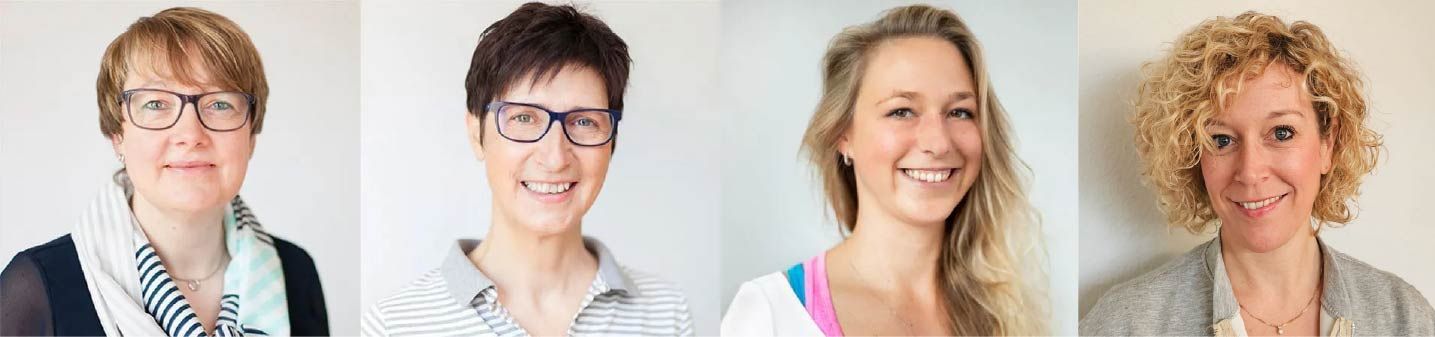 Eine Gruppe von Frauen posiert für ein Foto und lächelt in die Kamera.