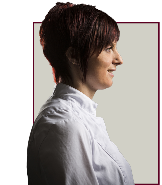 Profil d'une personne portant un uniforme de chef blanc sur fond neutre, encadré par une bordure bordeaux.