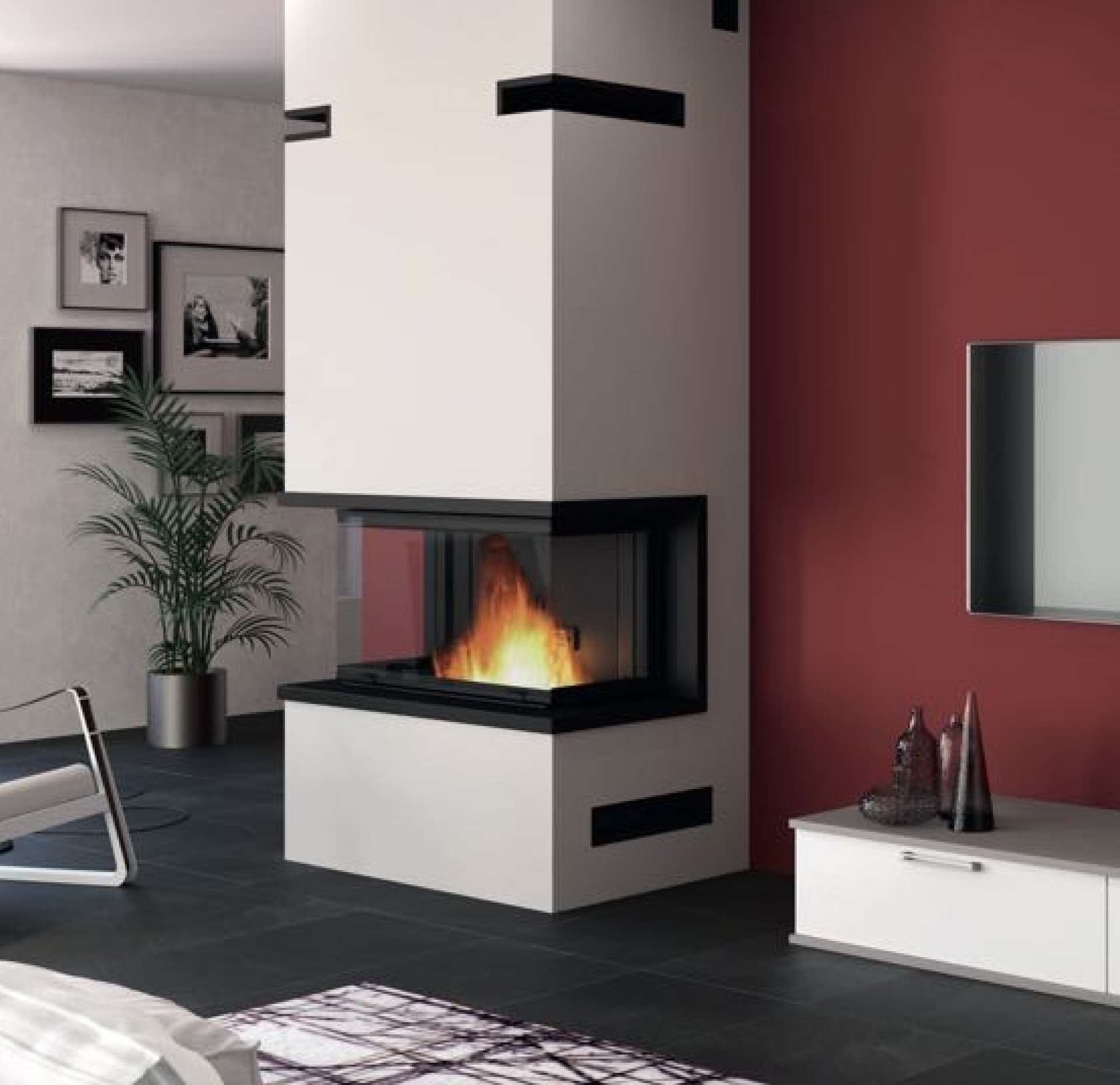 Cheminée d'angle blanche moderne avec flammes et touches de noir, près d'une plante et d'un mur rouge.