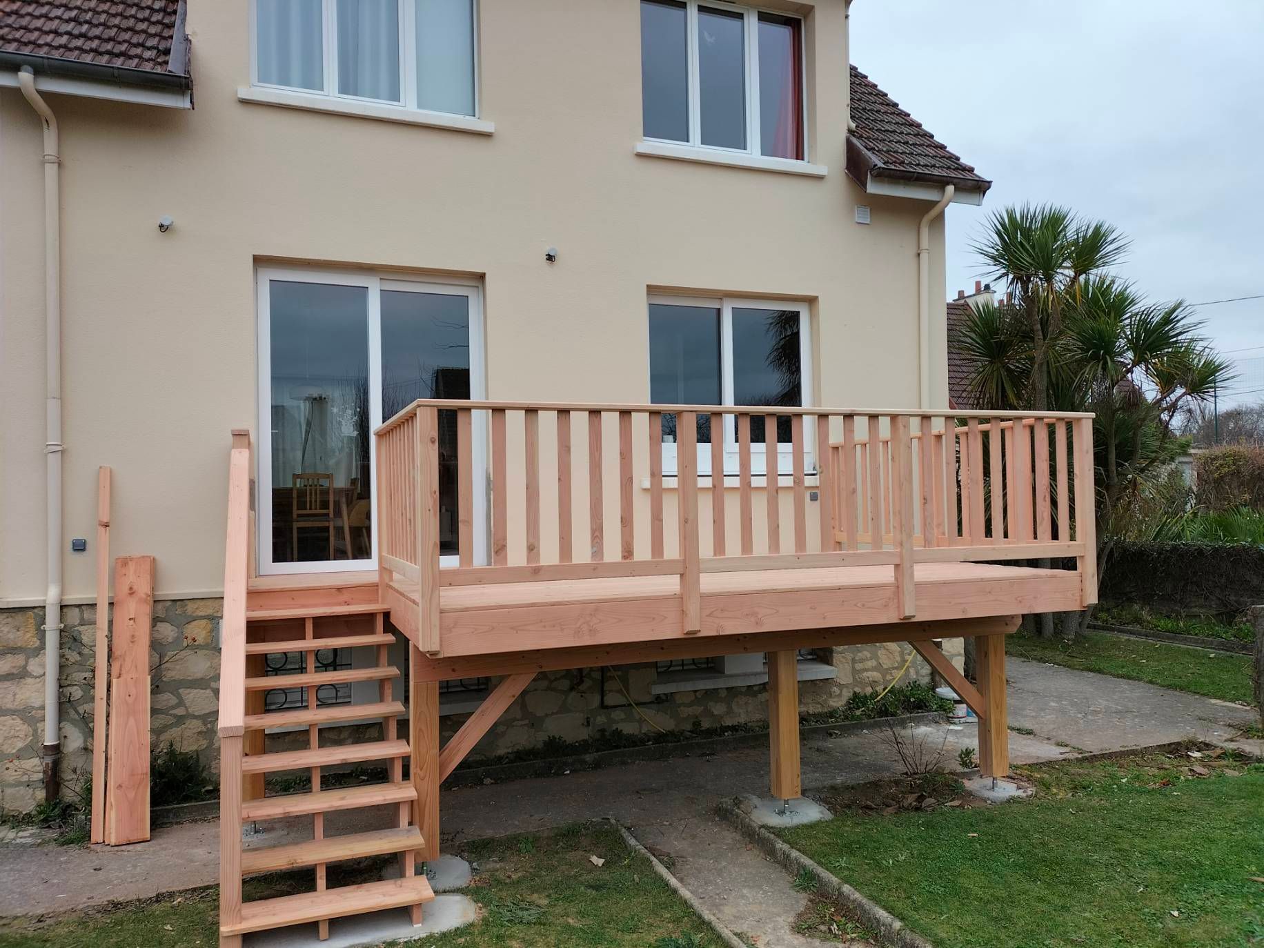 Terrasse en bois surélevée d'une maison avec accès par un escalier