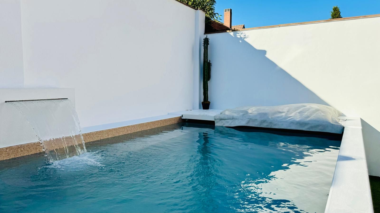 Una pequeña piscina con una cascada en el medio.