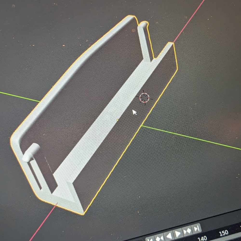 3D-Rendering eines grauen rechteckigen Objekts mit zwei abgewinkelten Seiten und einer Kerbe auf schwarzem Hintergrund.