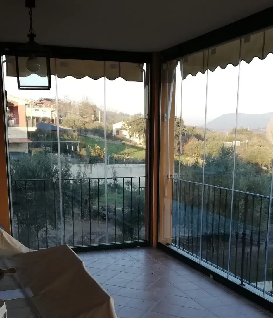 Una sala de estar con vista a un balcón y a las montañas.
