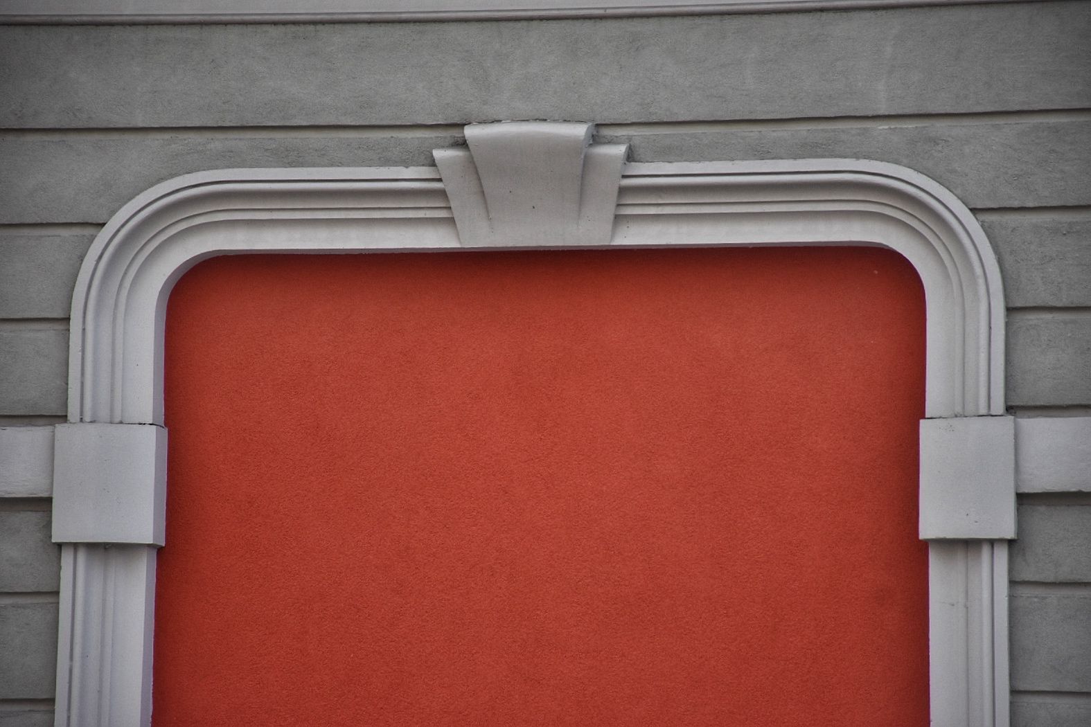 Un muro rosso con una cornice bianca.