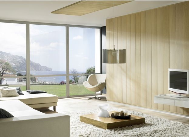 Ein Wohnzimmer mit einer Couch, einem Sessel und einem Fernseher
