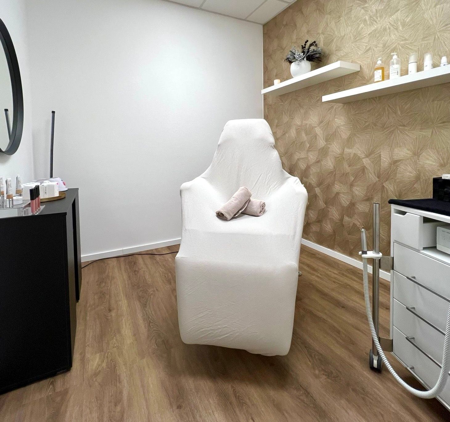 Ein weißer Stuhl steht in einem Raum neben einem Spiegel