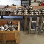 Edelstahlbauteile und Rohrverbindungen sortiert in Metallwerkstatt