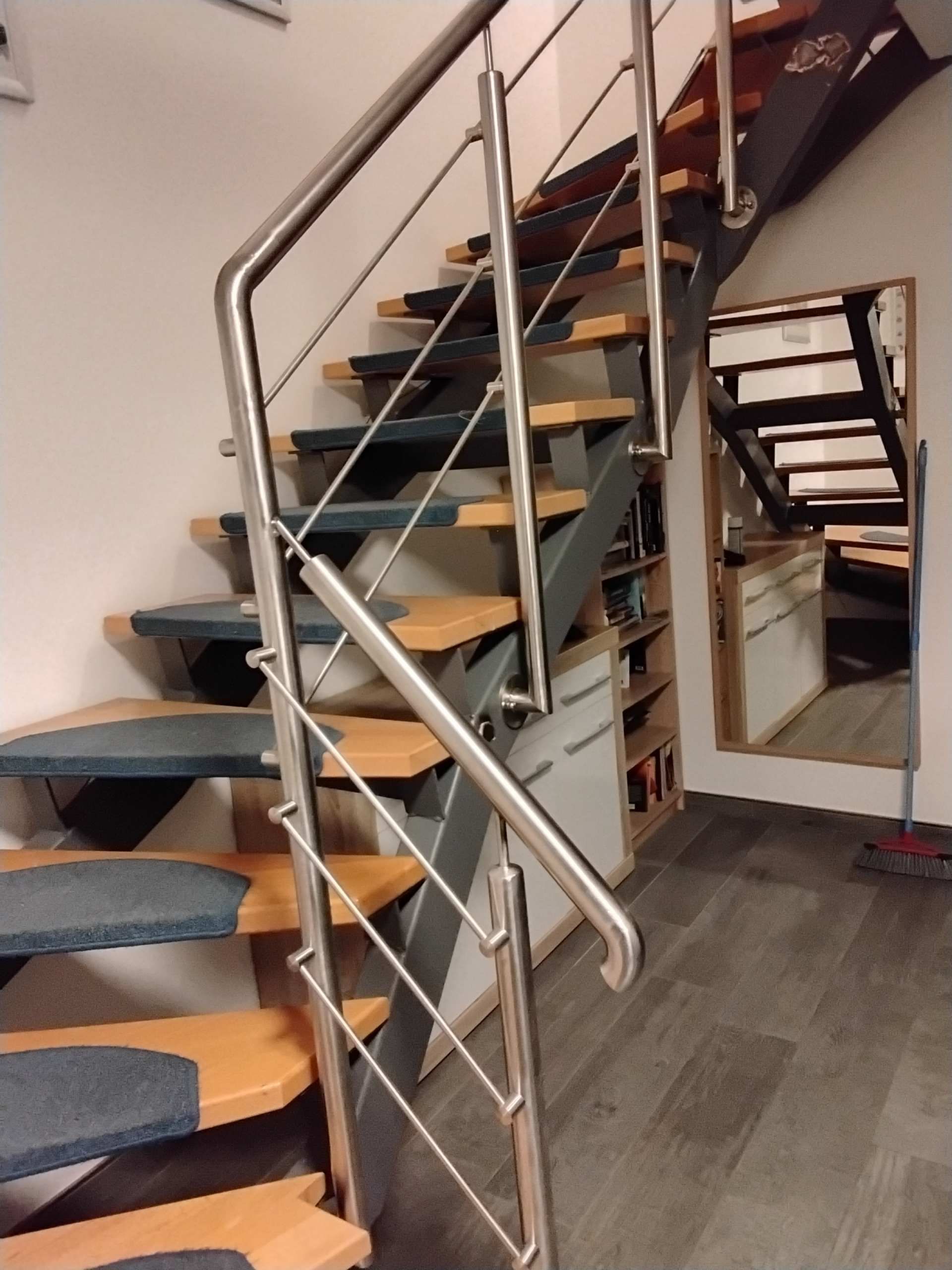Innentreppe mit Holzstufen und Edelstahlgeländer in einem modernen Wohnraum