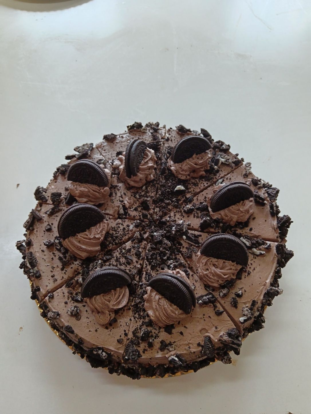 Pastel de chocolate con galletas Oreo y glaseado, cortado en ocho trozos.
