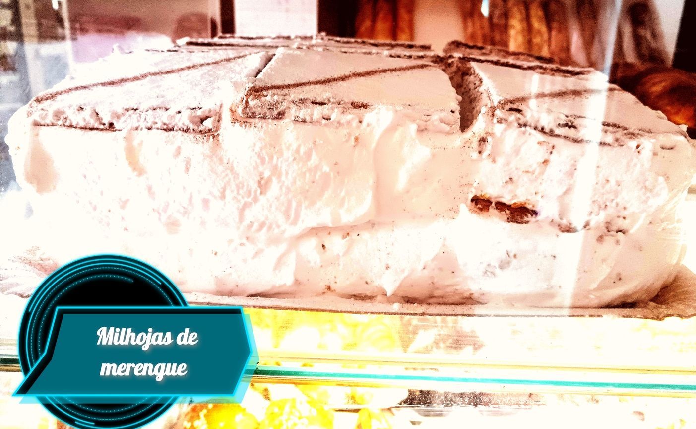 Sliced meringue cake, frosted, on display. Text: