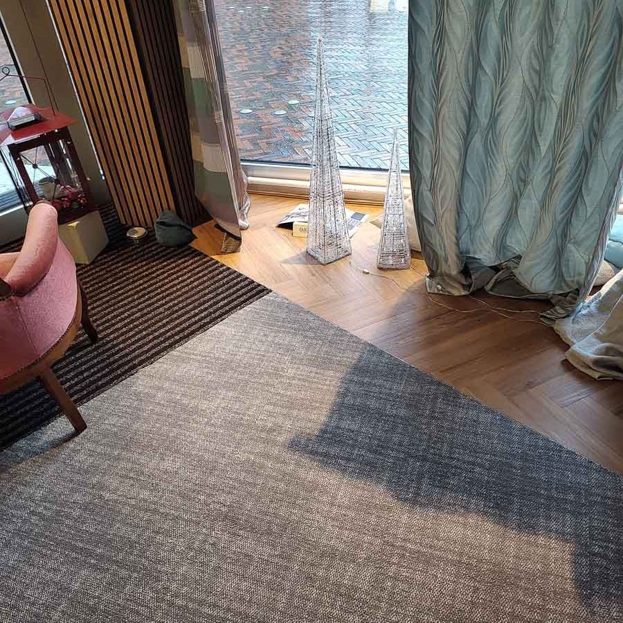 ein Wohnzimmer mit einem Teppich , einem Stuhl und einem Fenster - Koke Raumausstattung - Tobias Liebrand - vor Ort in Senden und Lüdinghausen