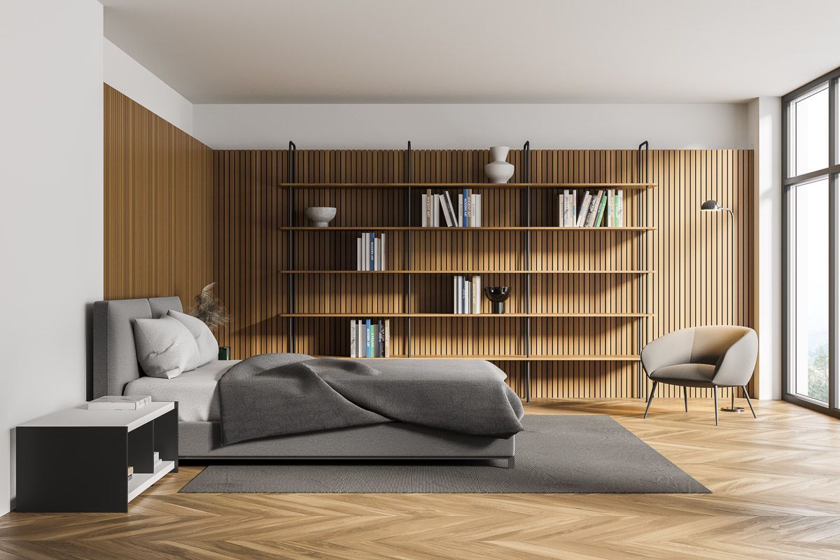 ein Schlafzimmer mit Bett , Stuhl und Bücherregalen - Bodenbeläge von Koke Raumausstattung - Tobias Liebrand - vor Ort in Senden und Lüdinghausen