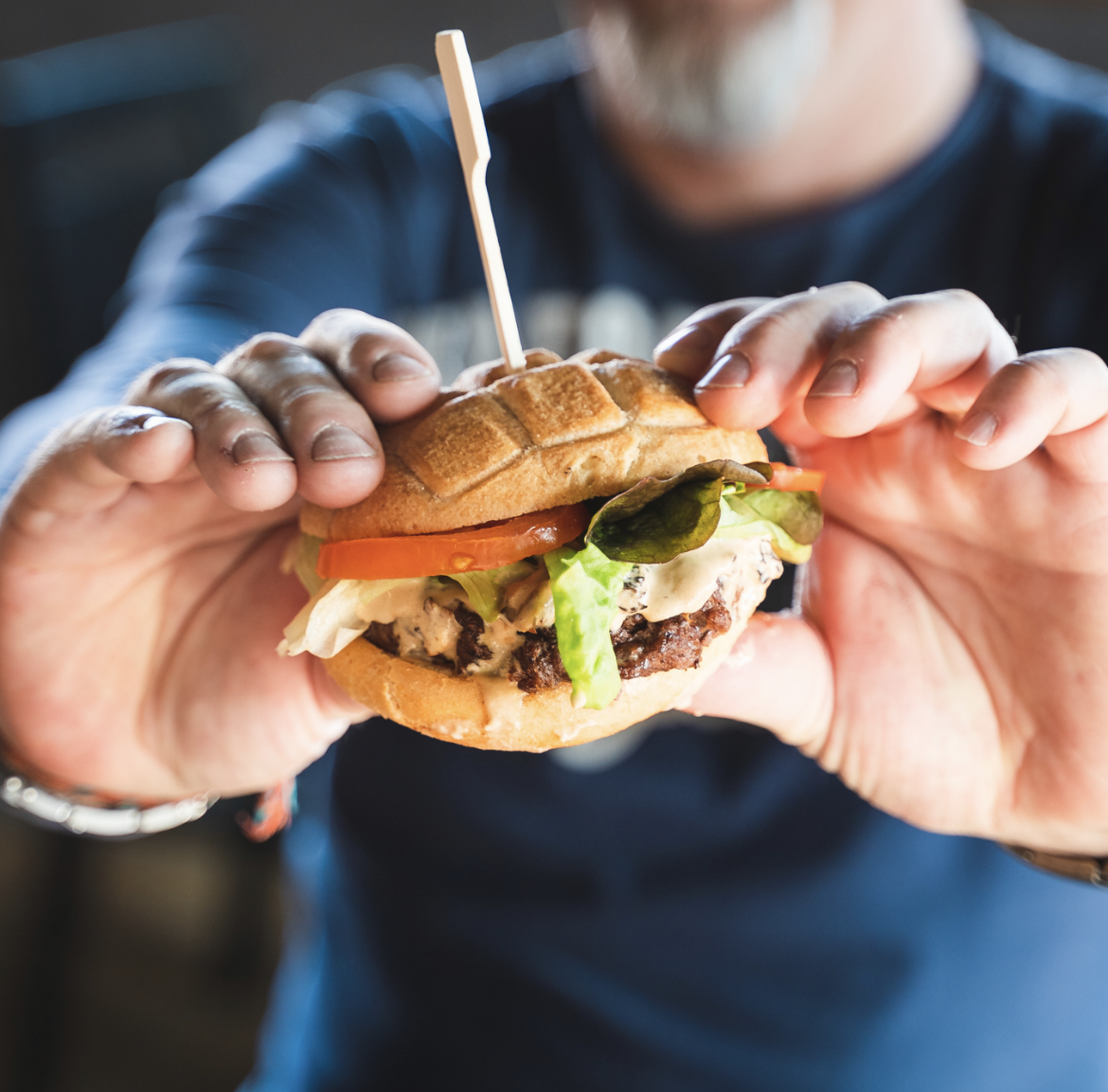 Personne qui tient un hamburger