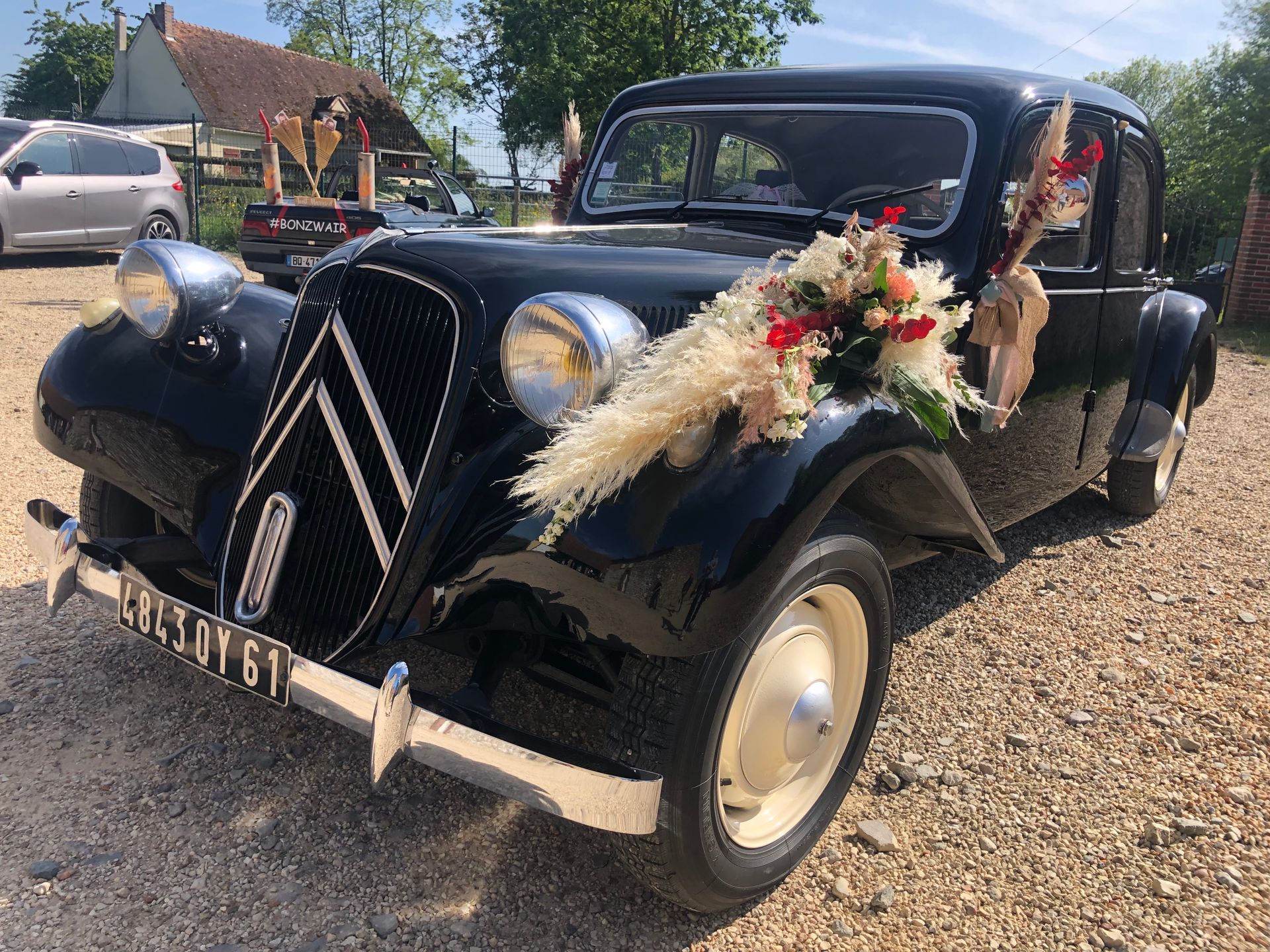Avant d'une Citroën traction et bouquet de fleur sur l'aile avant gauche