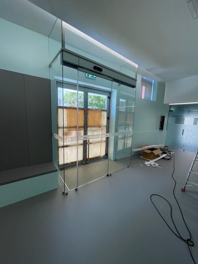 An empty room with a sliding glass door and a ladder.