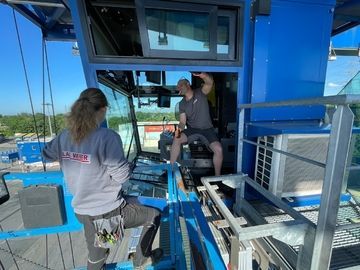 ein Mann und eine Frau stehen in der Kabine eines Krans