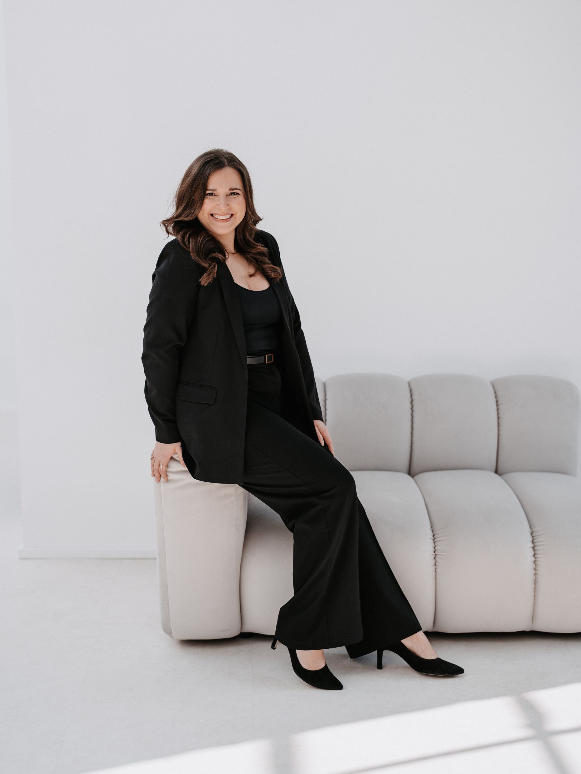 A woman is sitting in a bridal styling chair