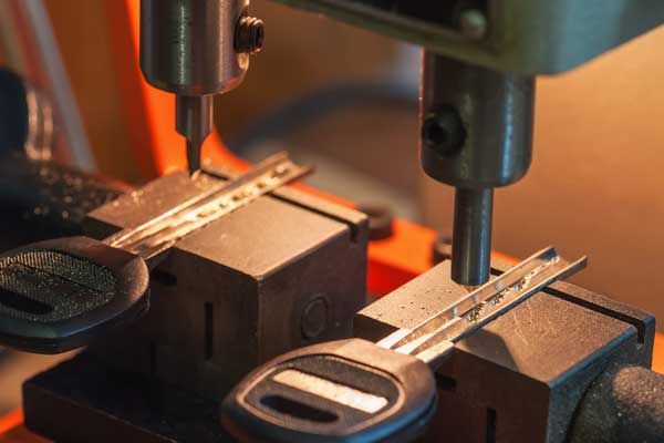 Un primer plano de una llave que se está cortando en una máquina.