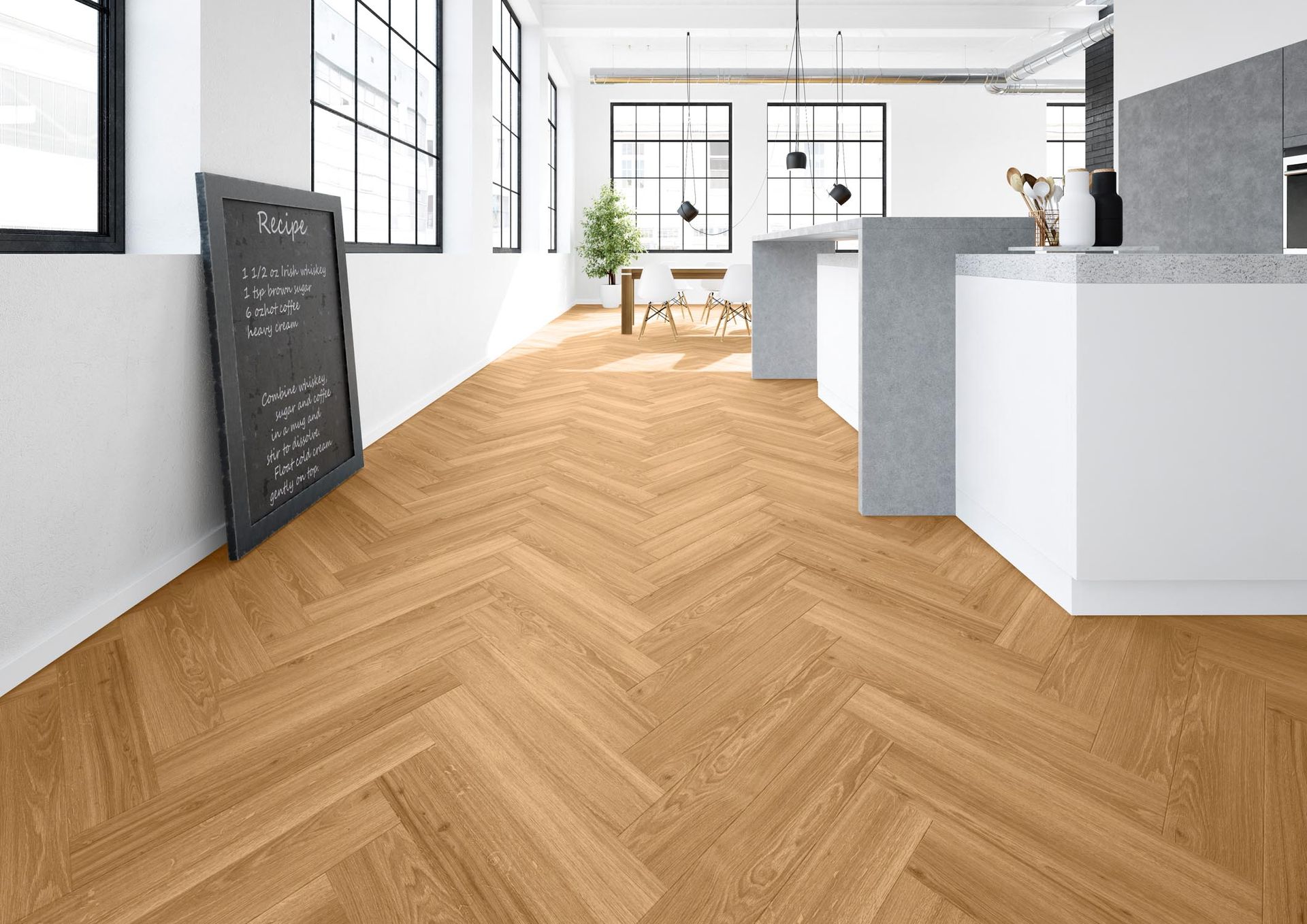 Eine Küche mit Holzboden und Fischgrätenmuster.