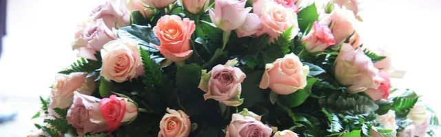 Un ramo de rosas rosadas está sentado sobre una mesa.