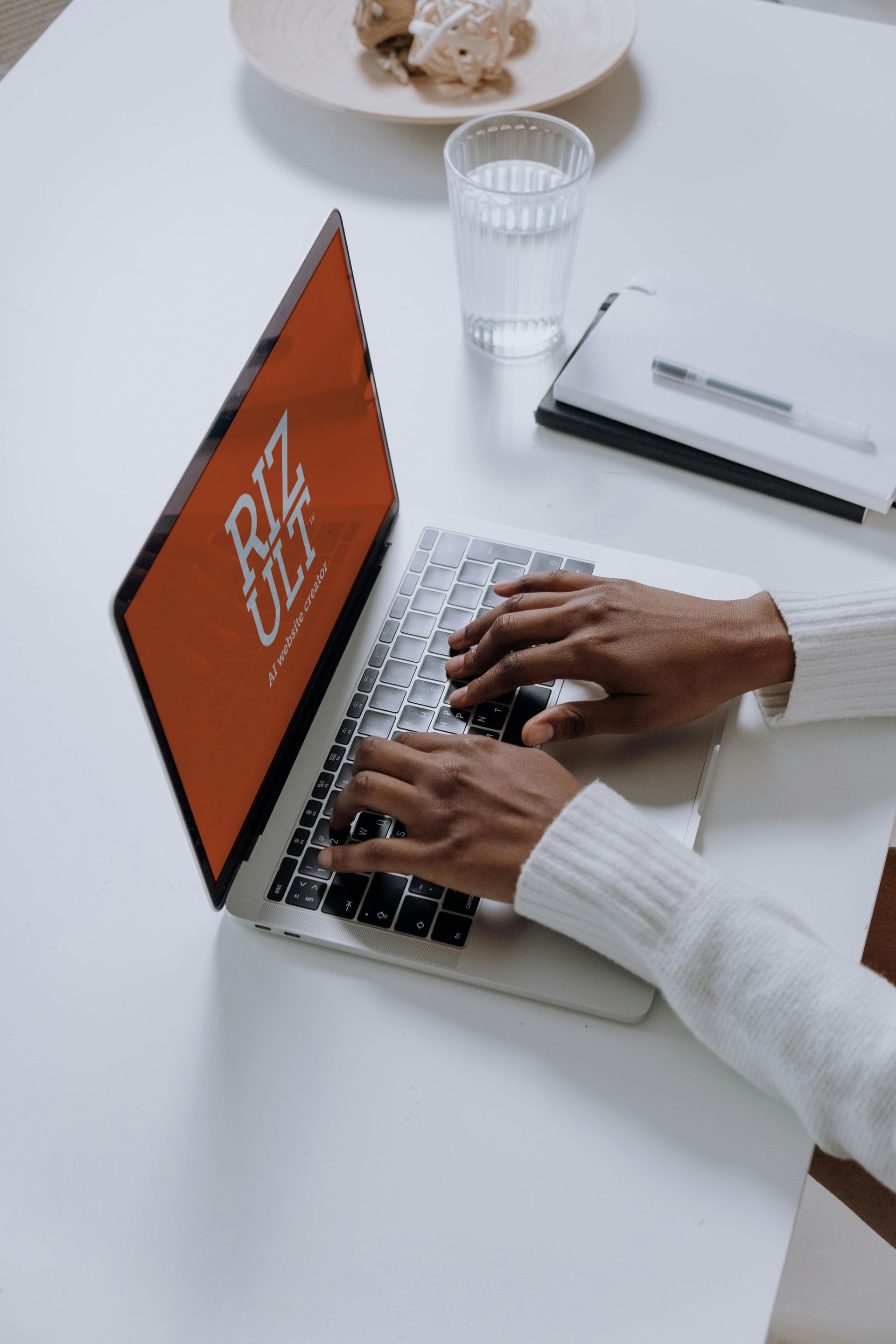 A person is typing on a laptop that says rtk on the screen