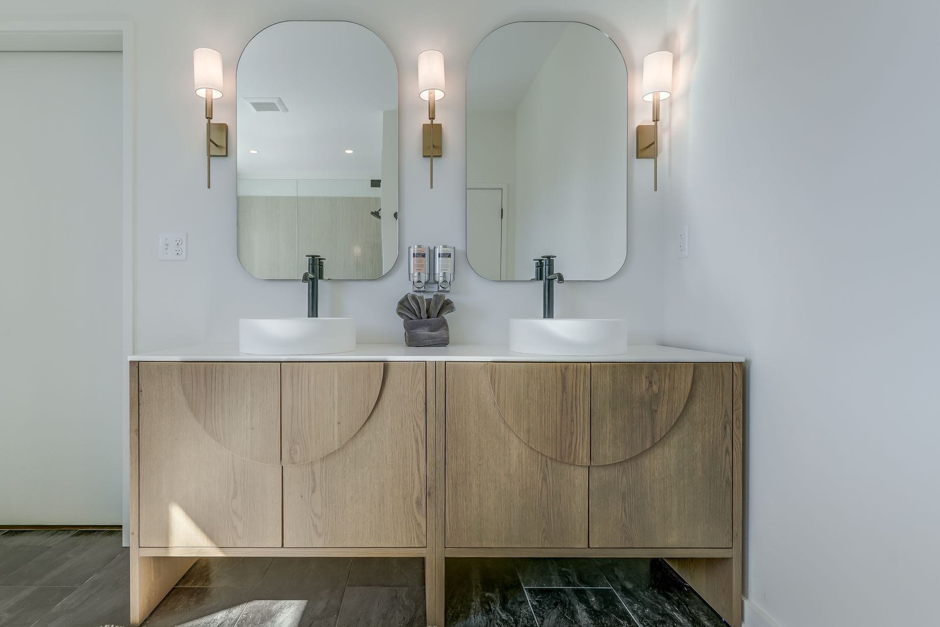 An ensuite bathroom with two sinks and two mirrors.