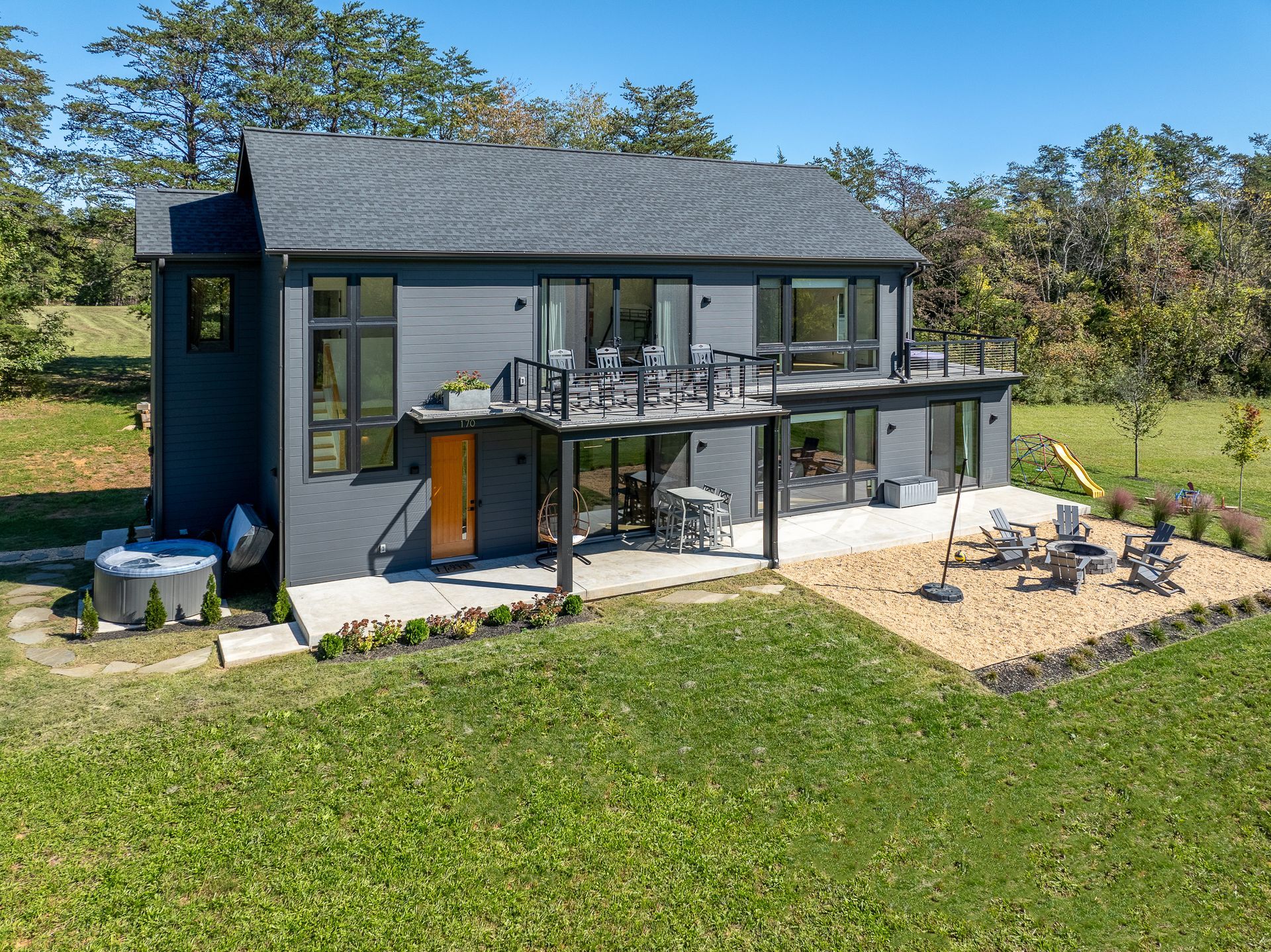 An aerial view of a luxury Afton vacation rental with a large lawn in front of it.