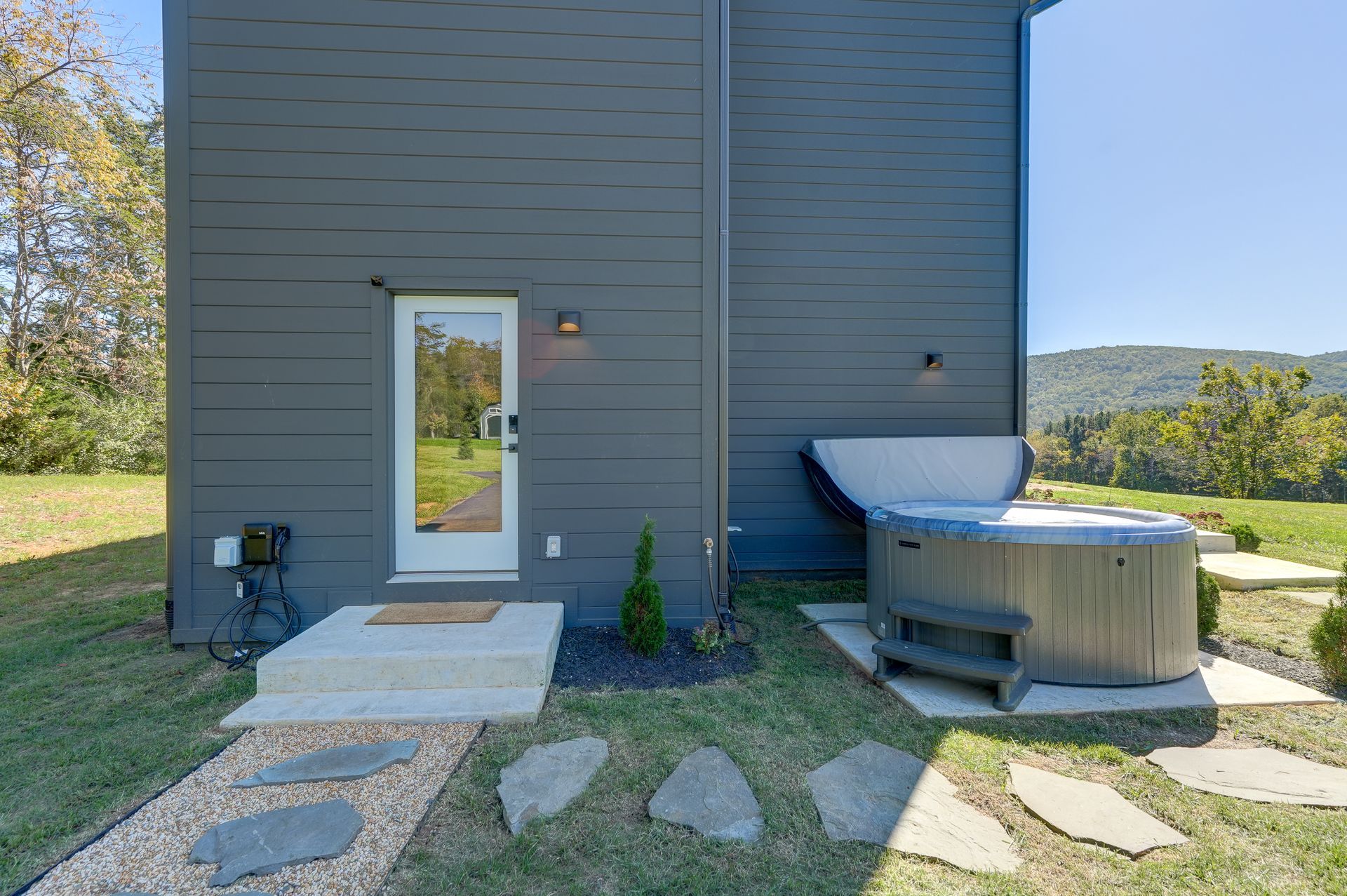 There is a hot tub in the backyard of a house.