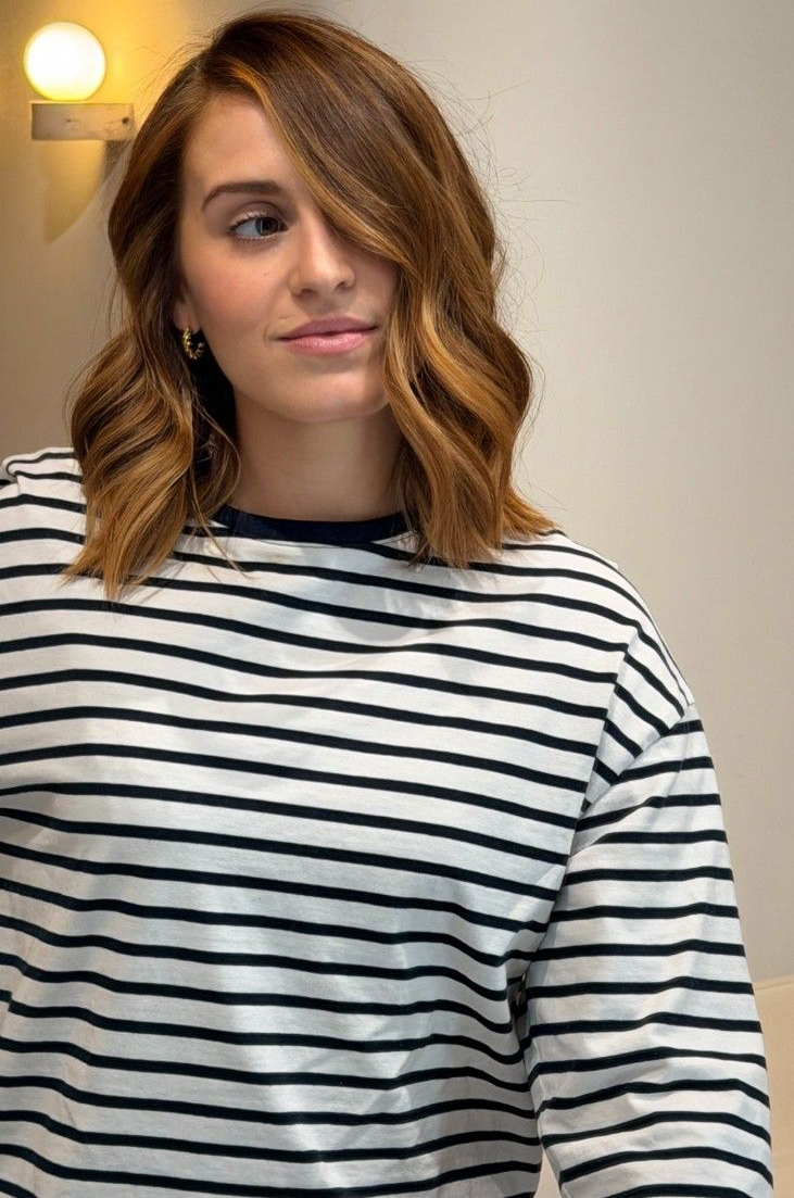 Dark brown wavy hair. Text: 