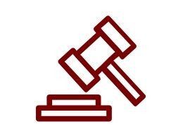 Mazo y bloque de color rojo, que representan la ley o la justicia.