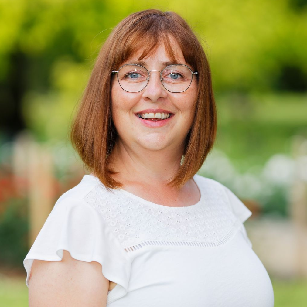 Frau steht vor Bergkulisse