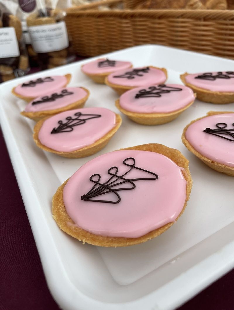Un plateau de cupcakes roses avec du chocolat dessus