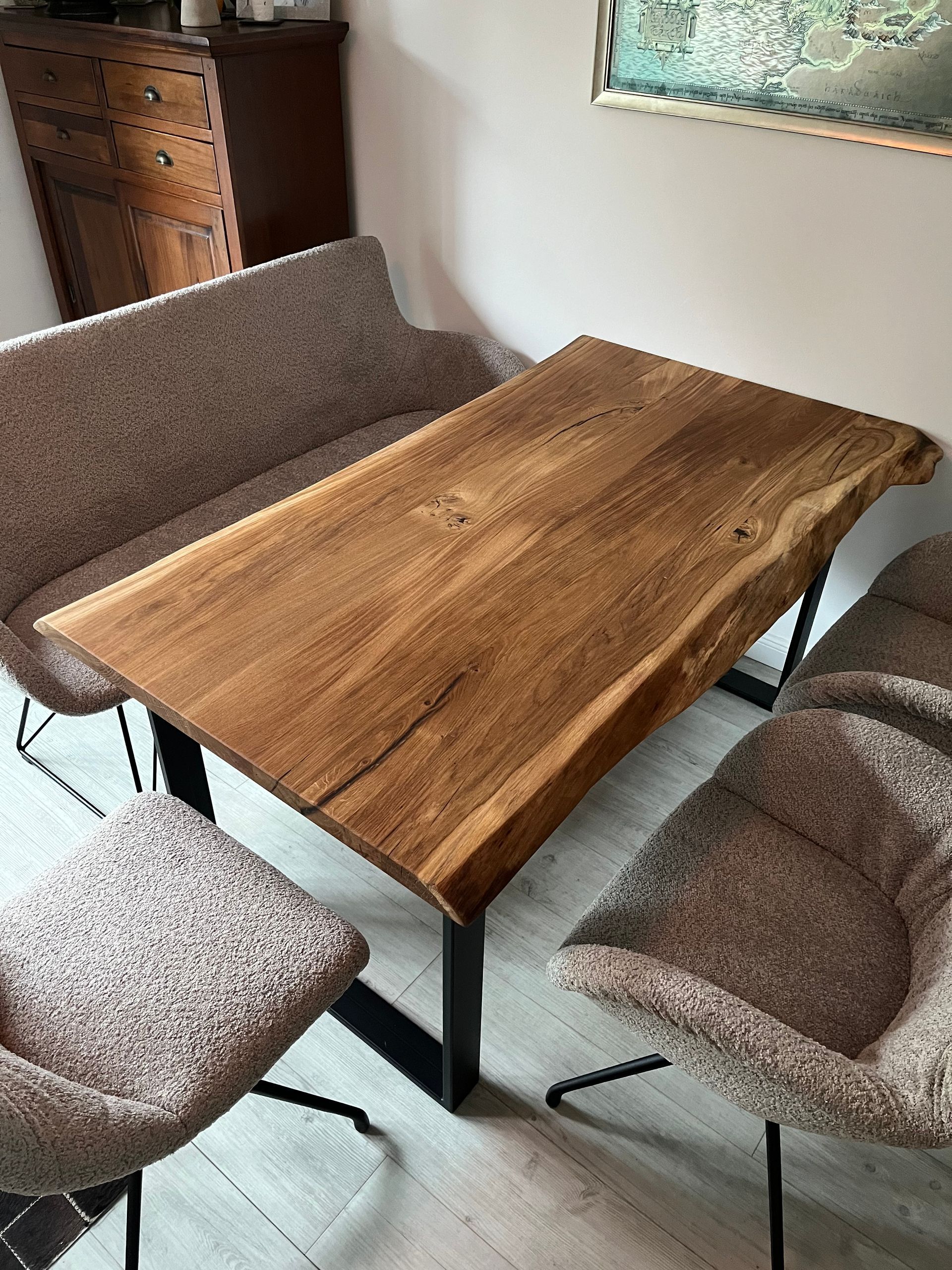 Esstisch aus Holz mit natürlicher Kante, Bank und Stühlen, im Innenbereich aufgestellt.