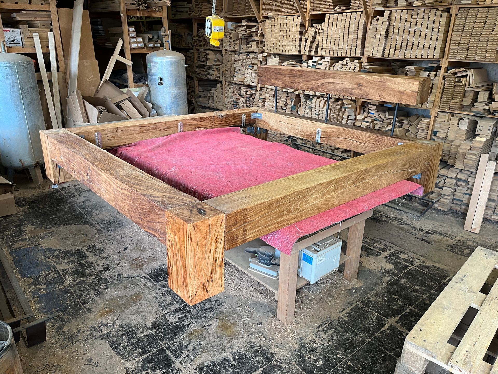 Ein zusammengebundener Stapel Holzbretter mit Baumrinde auf dem Lager zum trocknen