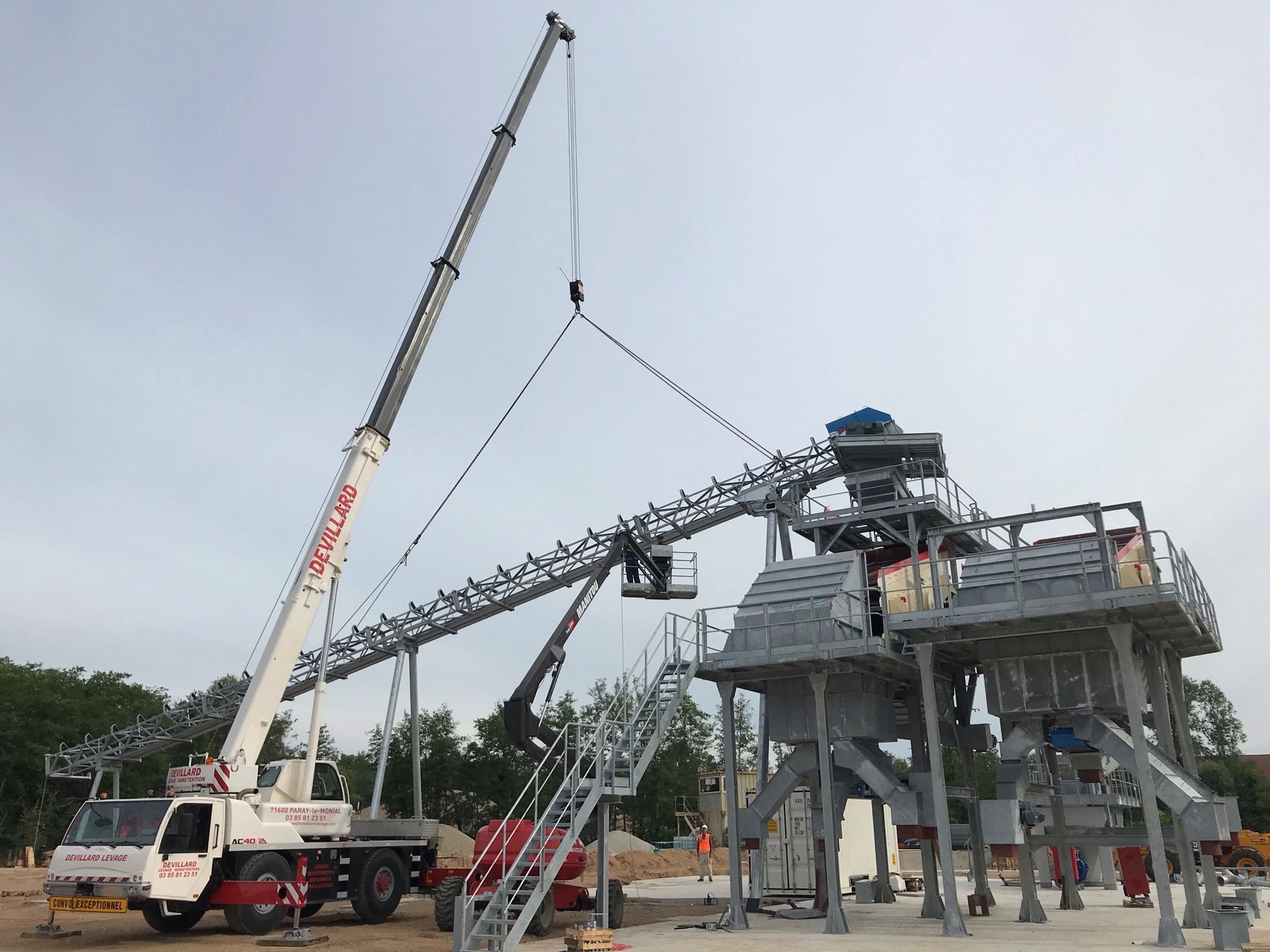 Un camion de levage portant des structures métalliques

