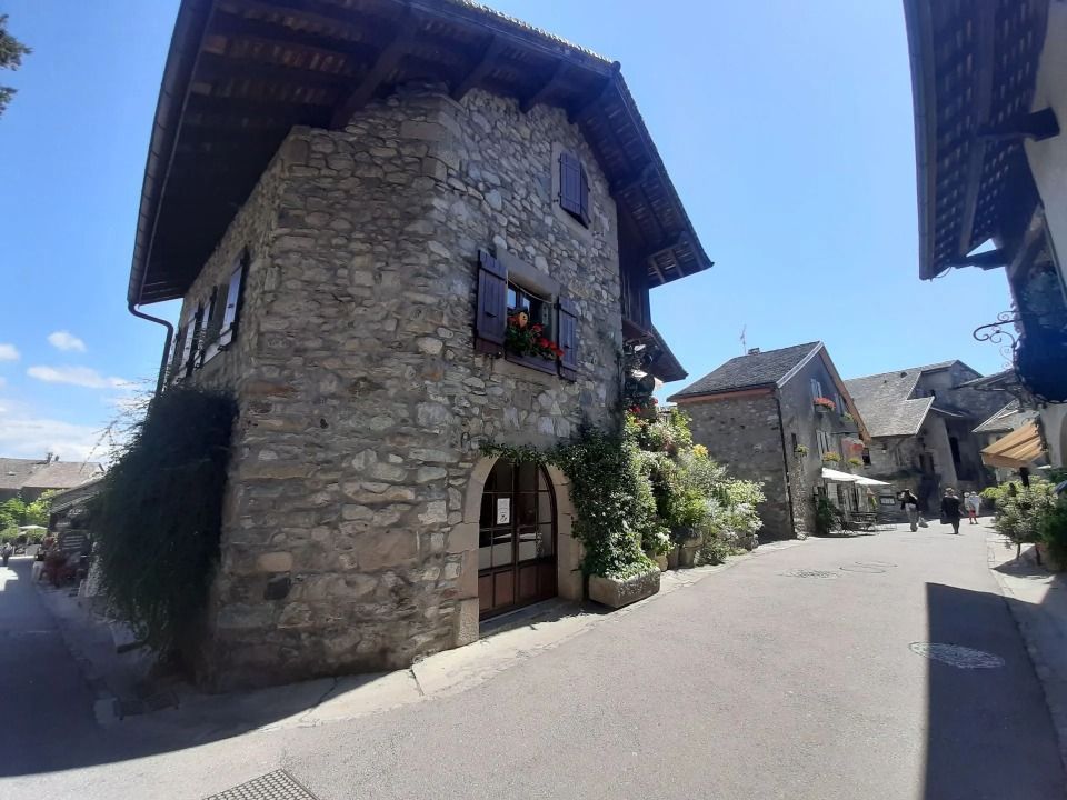 Un bâtiment en pierre se trouve au coin d'une rue.