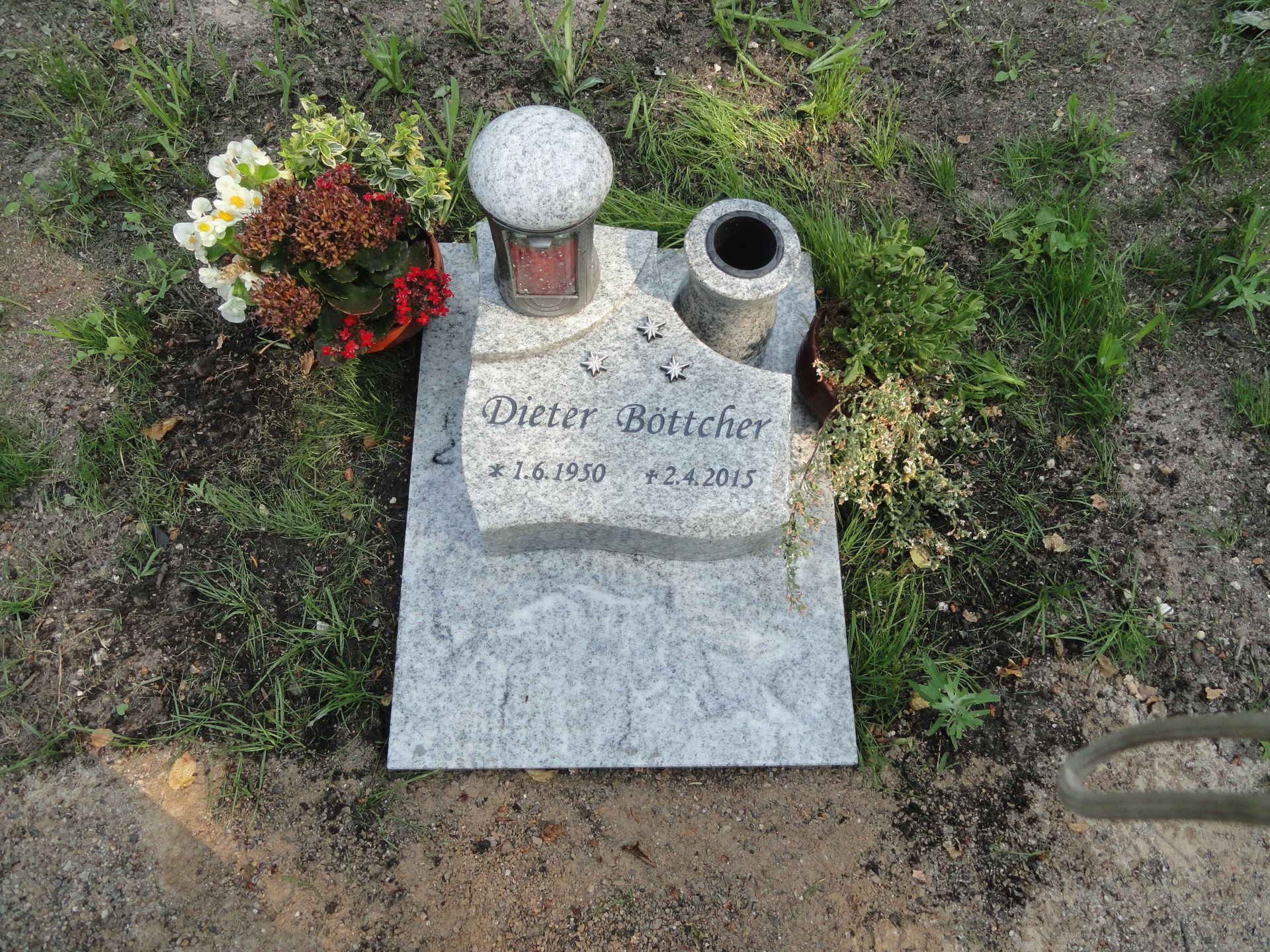 Grabstein mit Blumen, Gedenklampe und Vase. Name „Dieter Böttcher“ mit Geburts- und Sterbedatum.