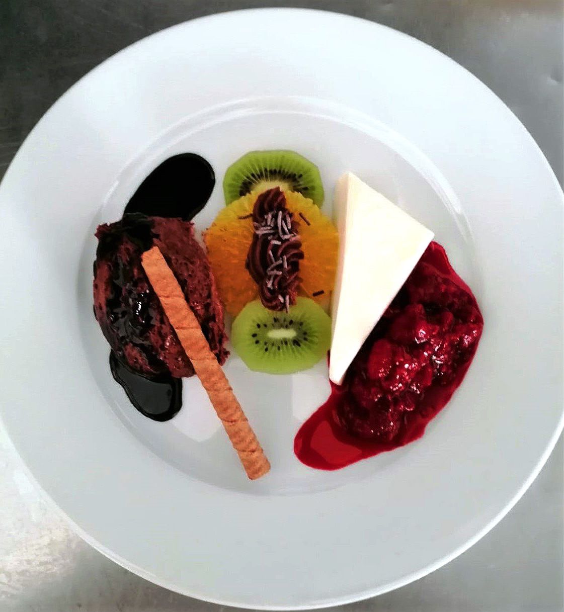 A white plate topped with a variety of desserts
