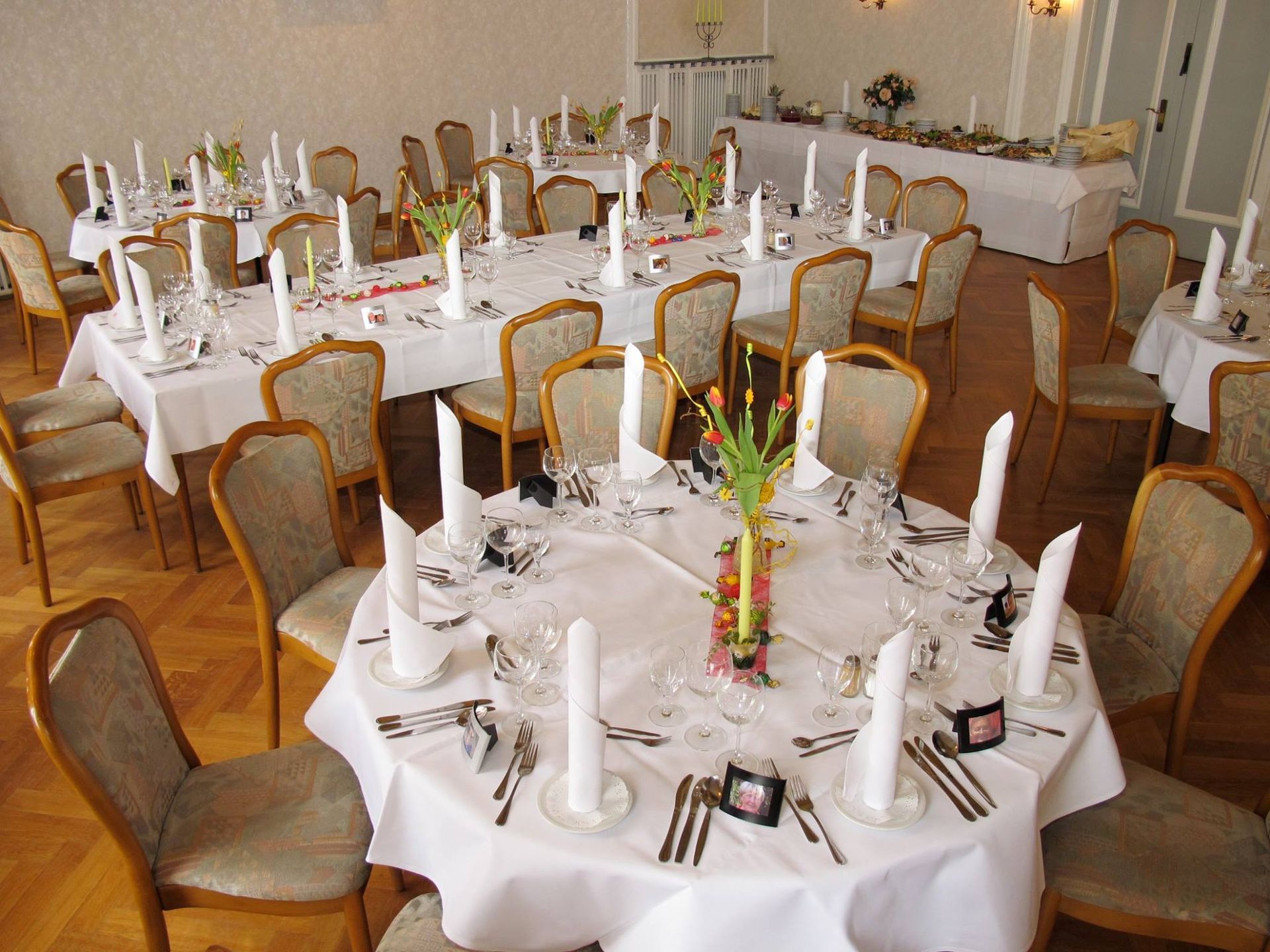 A large room with tables and chairs set up for a party