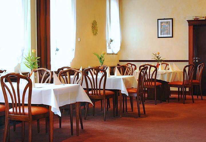 A restaurant with tables and chairs and a picture on the wall