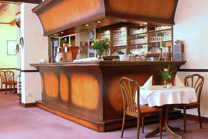 A restaurant with tables and chairs and a bar