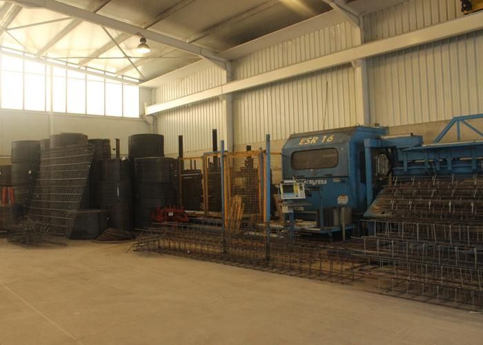 Un gran almacén con un tren azul en el medio.