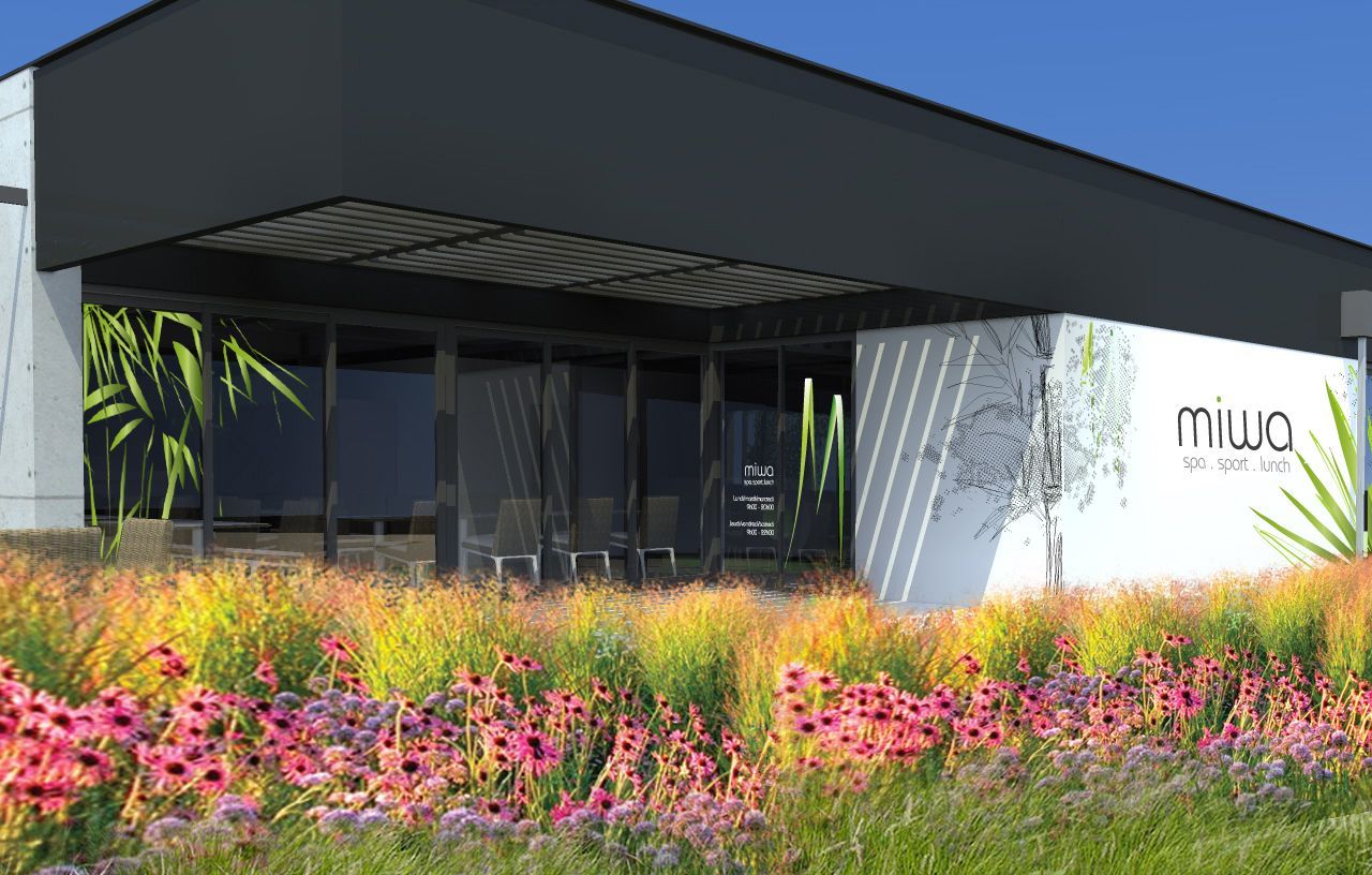 Entrée d'un bâtiment avec fleurs roses devant