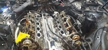 Un primer plano de un motor de automóvil con una flecha amarilla apuntando hacia él.