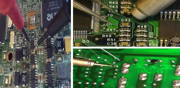 Una persona está trabajando en una placa base con un soldador.