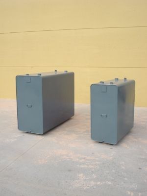 Hay dos cajas en el suelo frente a una pared amarilla.