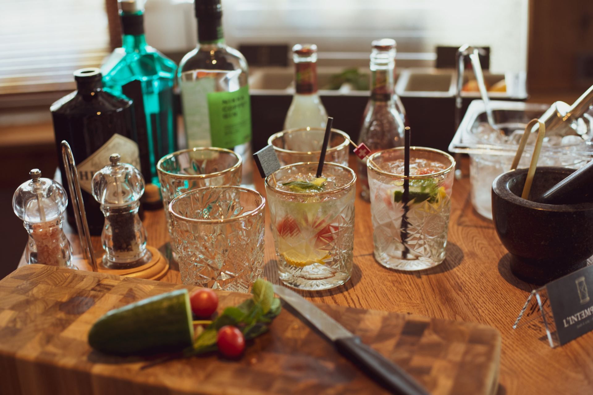 Une table en bois sur laquelle sont posées une variété de boissons et de bouteilles.